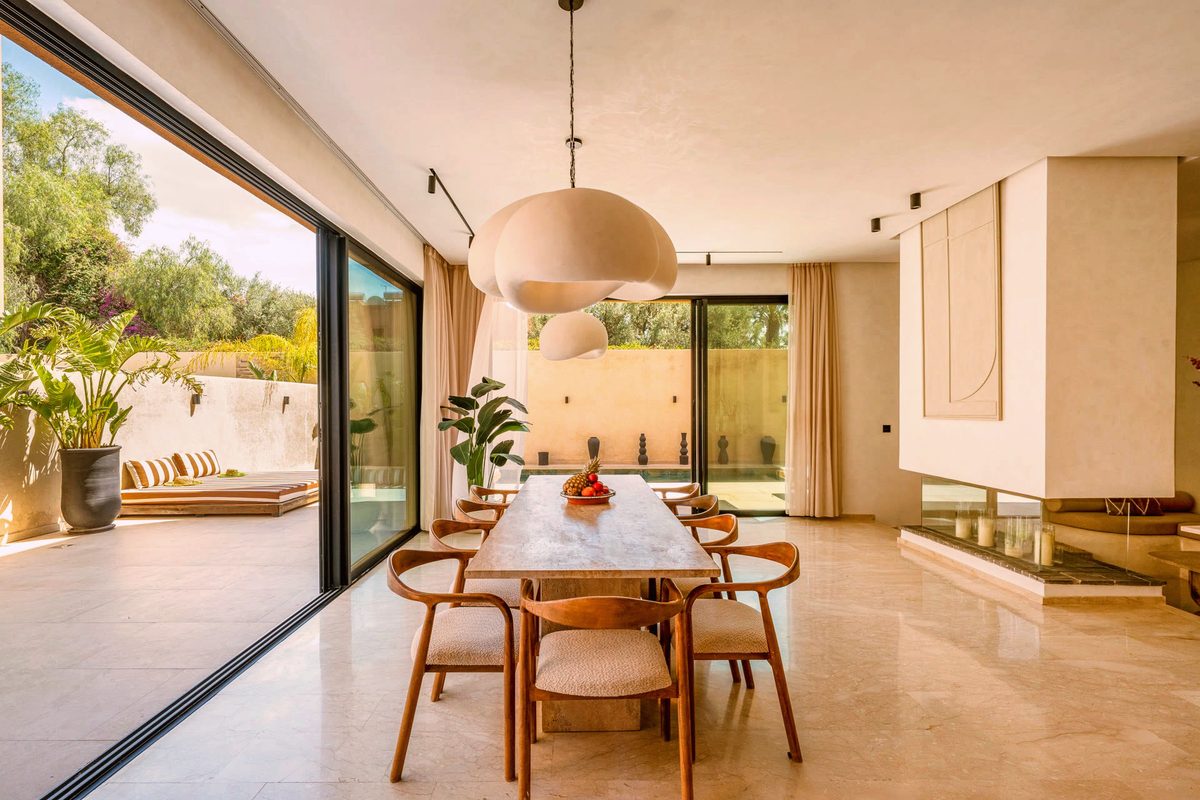 The dining room at Villa Camélia beneath its pendant light